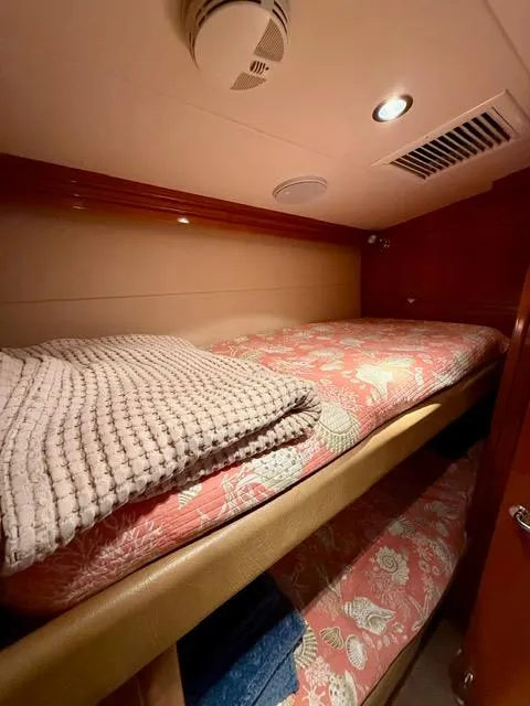 Slide: The Image of Cozy bunk beds in 2002 Hatteras 55 Convertible yacht cabin with floral bedding. - 67