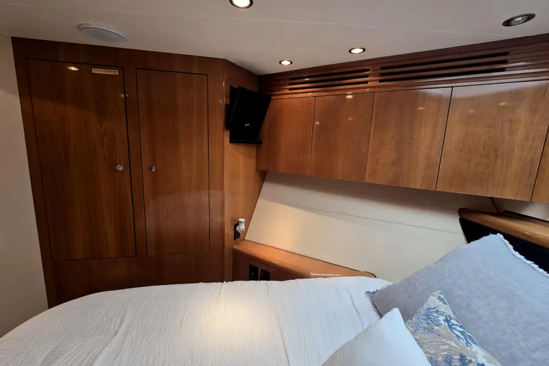 Slide: The Image of Luxurious cabin interior of 2002 Hatteras 55 Convertible yacht with wood paneling and cozy bedding. - 71