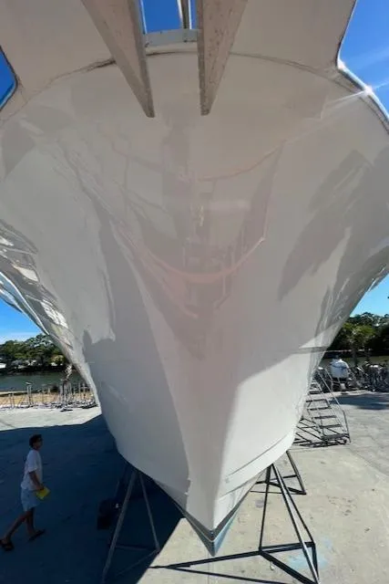 Slide: The Image of 2002 Hatteras 55 Convertible yacht on dry dock, viewed from the bow. - 9