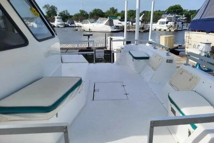 Slide: The Image of 1996 Gibson 50 Cabin Yacht docked, featuring spacious deck seating and marina view. - 5