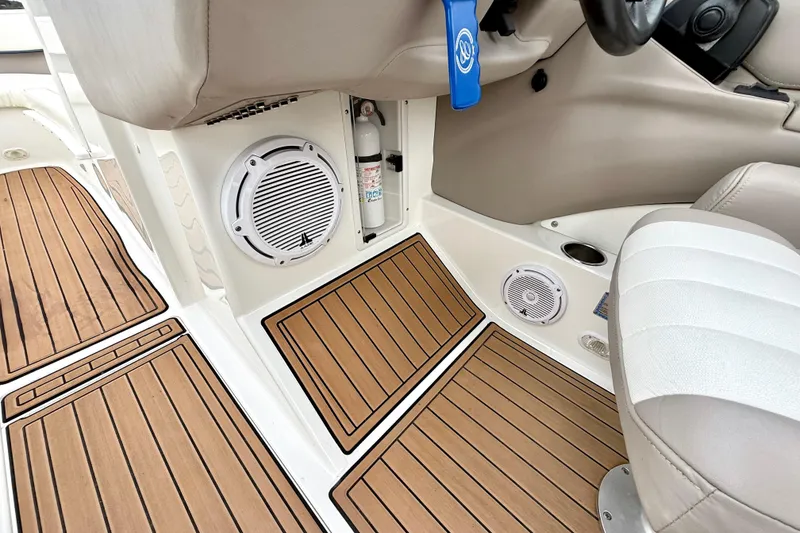 Slide: The Image of 2005 Cobalt 262 boat interior with teak flooring, speakers, and fire extinguisher. - 24