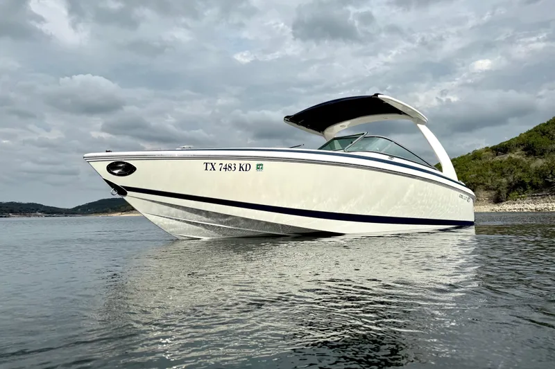 Slide: The Image of 2005 Cobalt 262 boat on calm water under cloudy sky. - 3