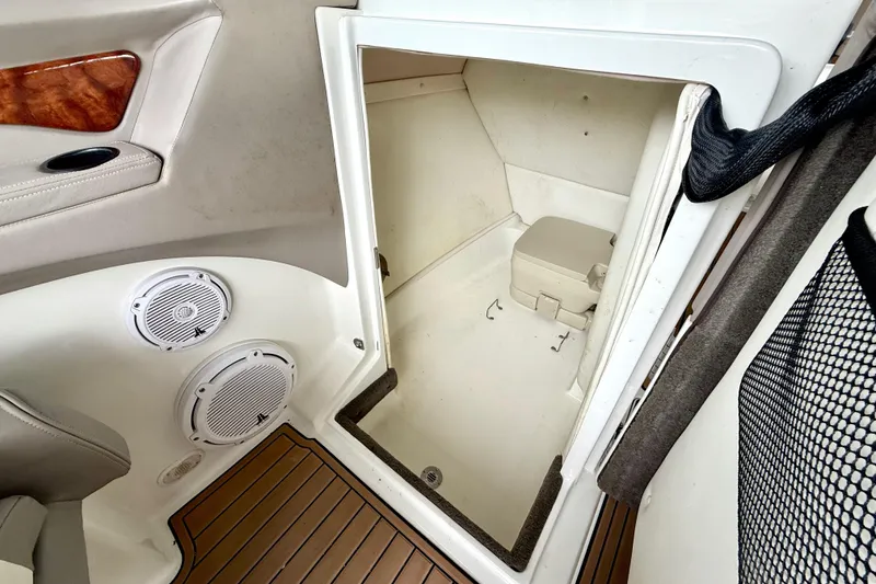 Slide: The Image of 2005 Cobalt 262 boat interior with speakers and compact cabin space. - 30