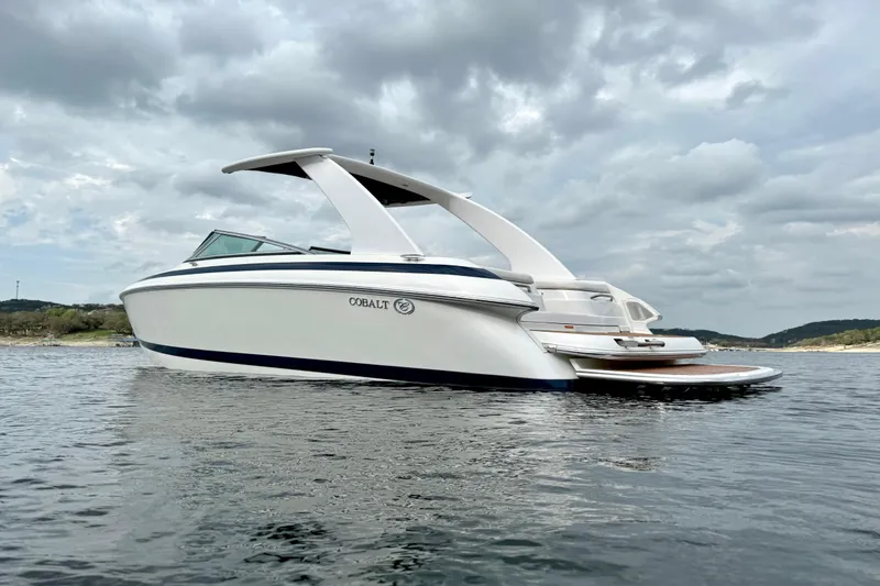 Slide: The Image of 2005 Cobalt 262 boat on water under cloudy sky. - 4