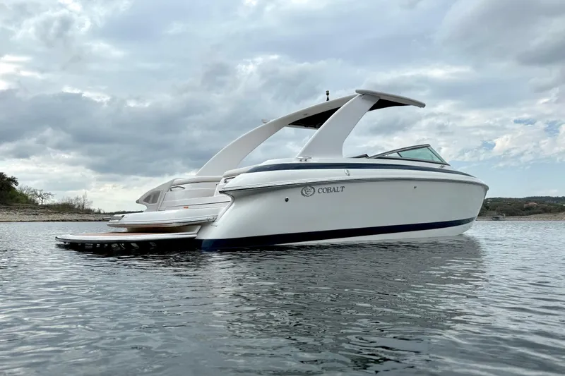 Slide: The Image of 2005 Cobalt 262 boat on calm water under cloudy sky. - 6