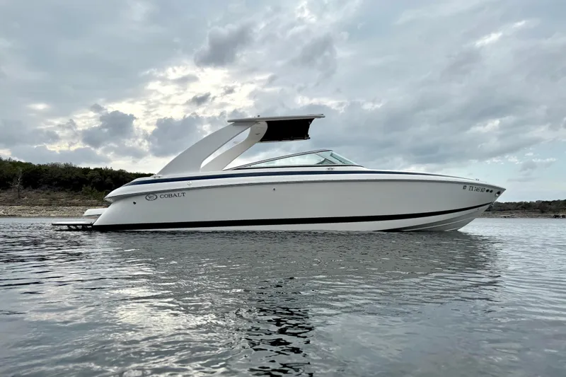 Slide: The Image of 2005 Cobalt 262 boat on calm water under cloudy sky. - 7