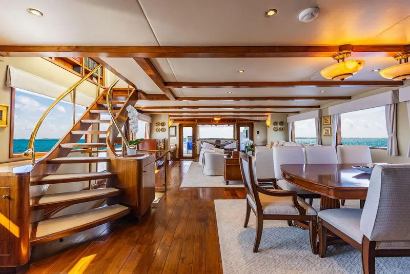 Slide: The Image of Luxurious yacht dining area with elegant table, modern lighting, and ocean view windows. - 10