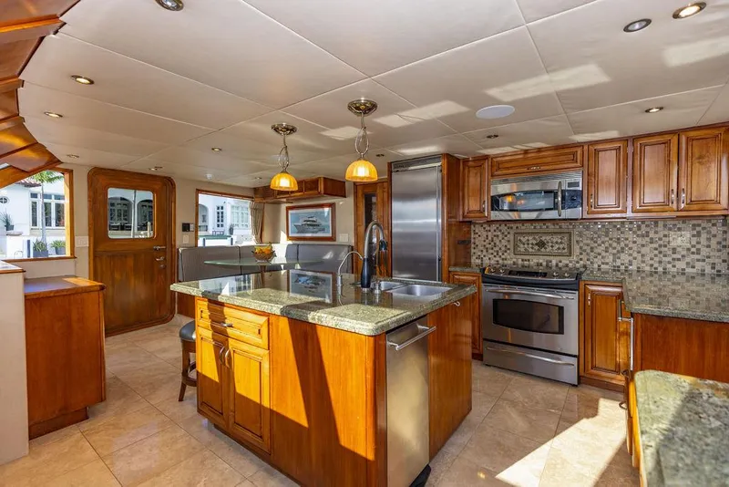 Slide: The Image of Luxurious yacht kitchen with wood cabinetry and granite island, built in 2009. - 12