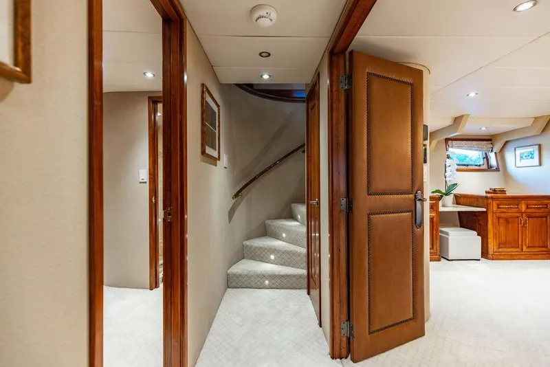Slide: The Image of Luxurious yacht bathroom with elegant wood vanity, marble countertop, and glass shower enclosure. - 15