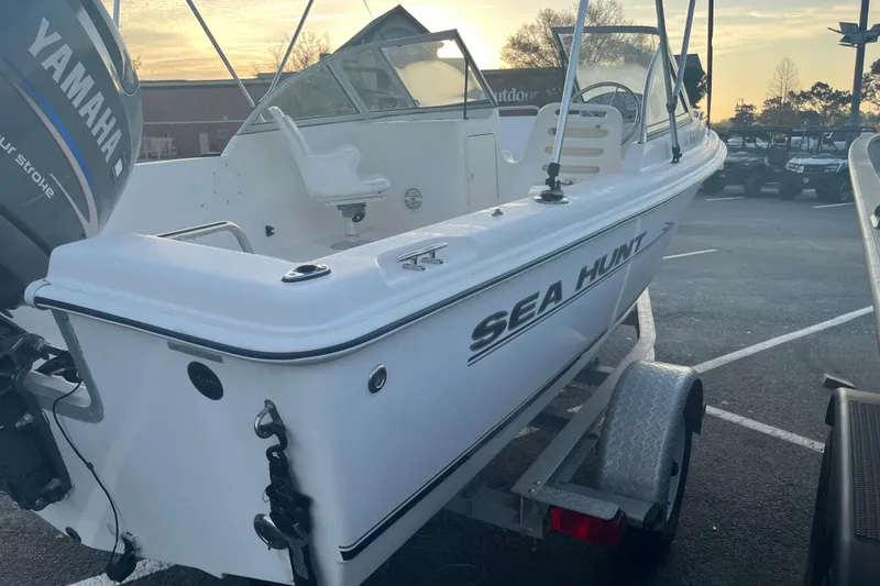 Slide: The Image of 2006 Sea Hunt Escape 175 boat on trailer with Yamaha outboard motor at sunset. - 2