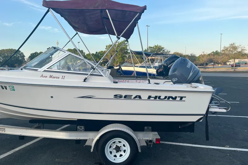 Slide: The Image of 2006 Sea Hunt Escape 175 boat on trailer with Yamaha outboard motor, parked outdoors. - 5