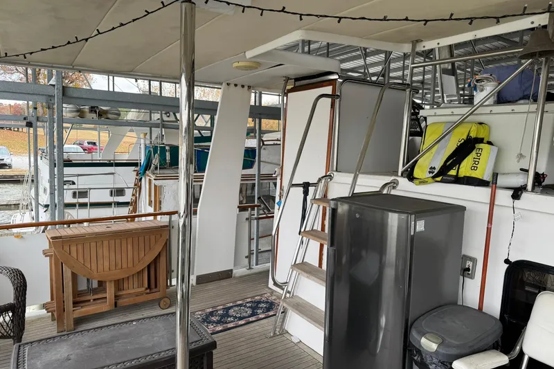 Slide: The Image of 1991 DeFever 44 yacht interior with wooden furniture, fridge, and safety equipment. - 30