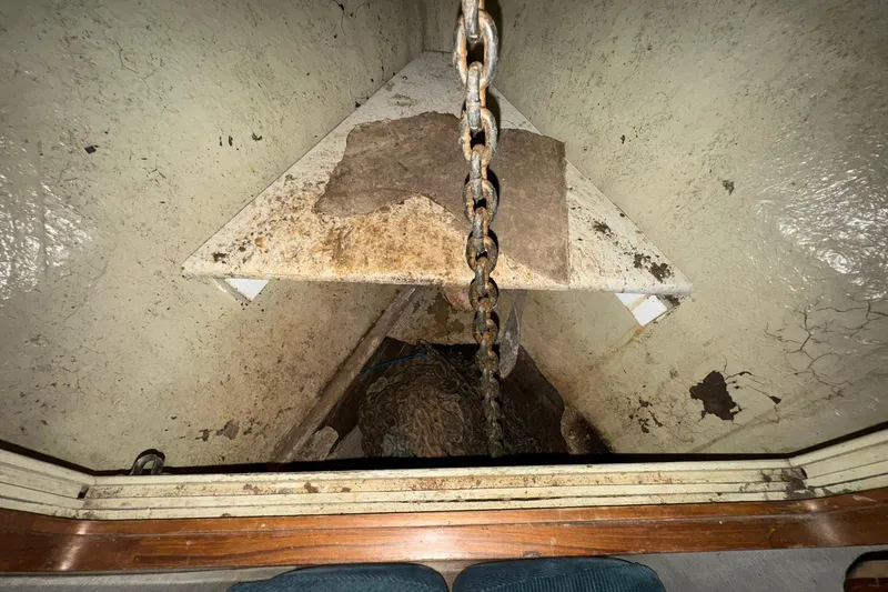Slide: The Image of Anchor chain compartment of 1991 DeFever 44 boat, showing rust and wear. - 62