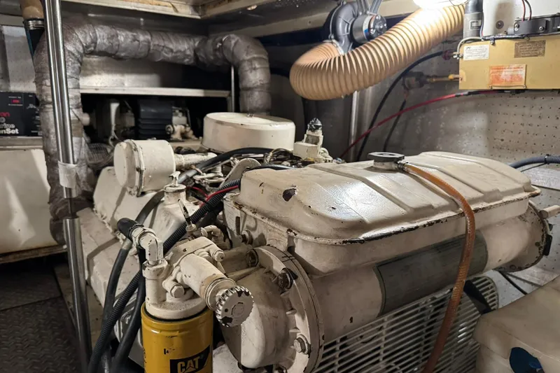 Slide: The Image of Engine room of a 1991 DeFever 44 yacht, featuring a CAT engine and ventilation system. - 71