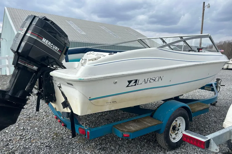 Slide: The Image of 1993 Larson All American 160 boat on trailer with Mercury outboard motor. - 3