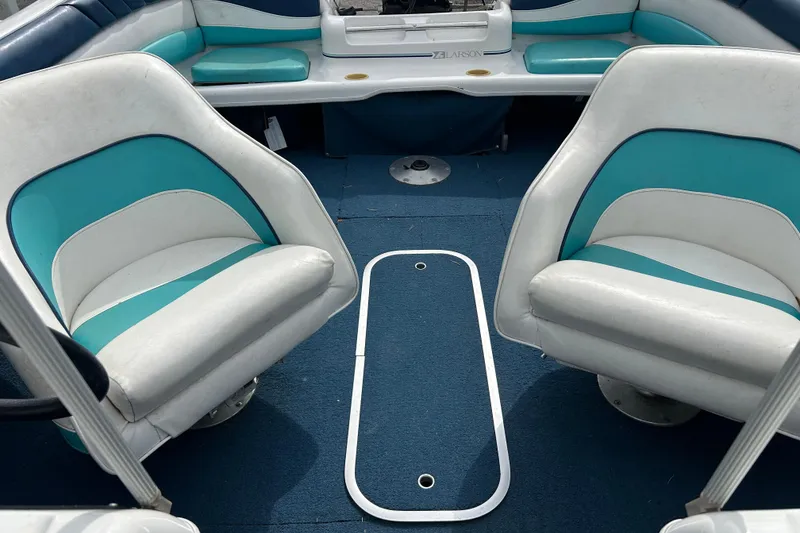 Slide: The Image of Interior of a 1993 Larson All American 160 boat with blue and white seating. - 8