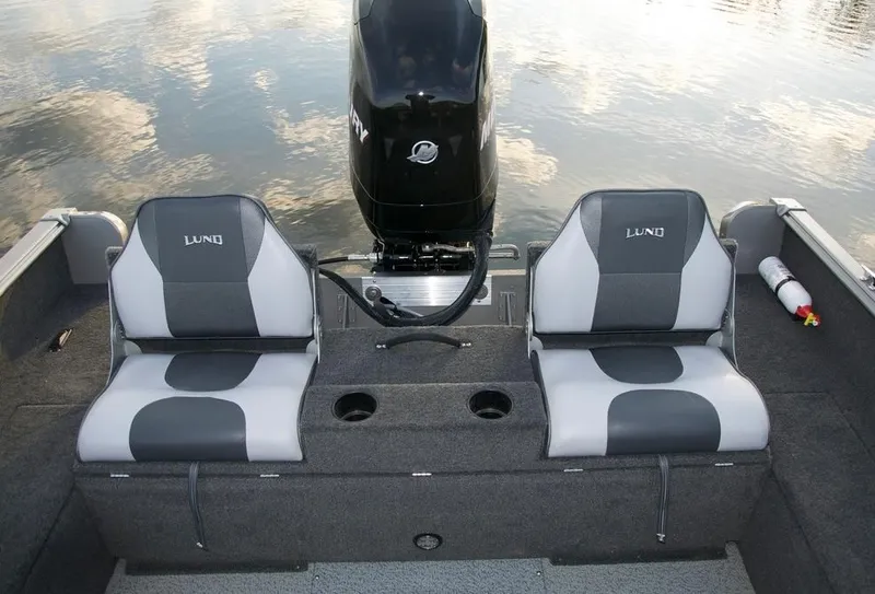 Slide: The Image of 2012 Lund 1775 Impact boat with Evinrude motor in a workshop. - 6