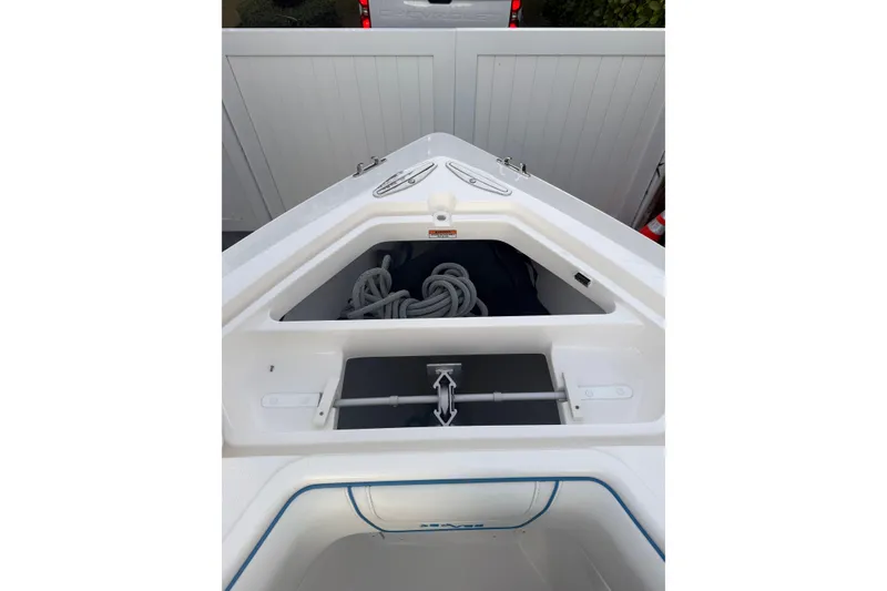 Slide: The Image of 2024 SeaVee 290B boat bow with anchor storage and coiled rope. - 12