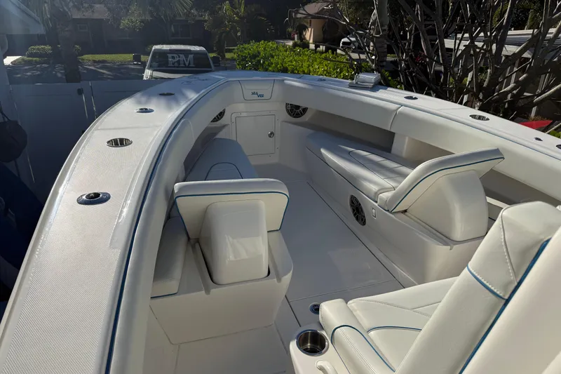 Slide: The Image of 2024 SeaVee 290B boat interior with white seating and blue accents, showcasing modern design. - 4