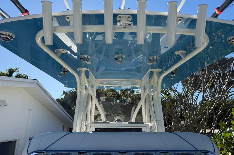Slide: The Image of 2024 SeaVee 290B boat with blue T-top and rod holders, viewed from below. - 6