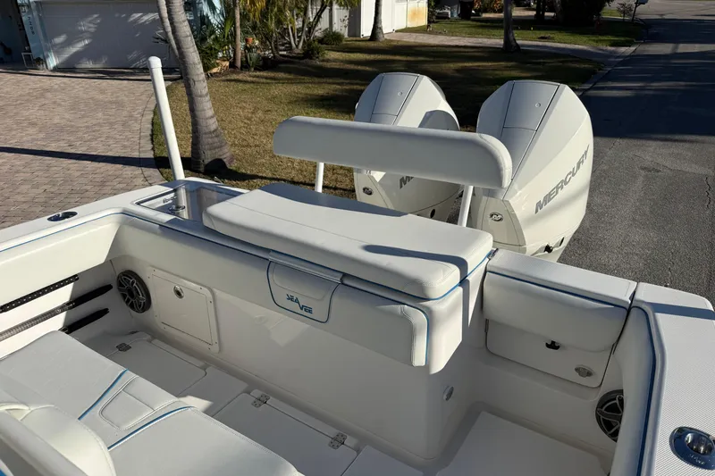 Slide: The Image of 2024 SeaVee 290B boat with dual Mercury engines, featuring a spacious seating area. - 9