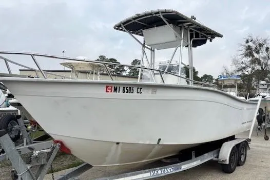 The Image of 1995 Cape Horn 21 boat on trailer, white hull, center console, outdoor setting. - 1