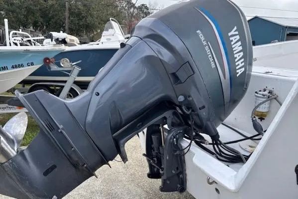 Slide: The Image of 1995 Cape Horn 21 boat with Yamaha four-stroke outboard motor in a marina setting. - 10