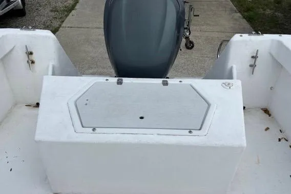 Slide: The Image of 1995 Cape Horn 21 boat interior with storage compartment and motor. - 11