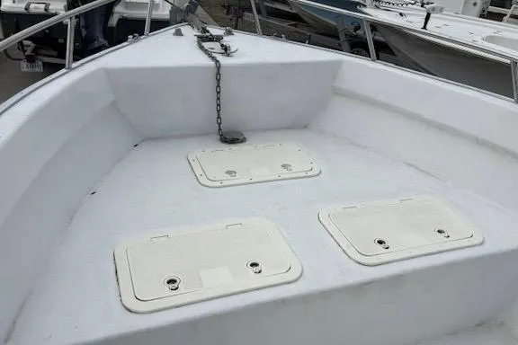 Slide: The Image of Bow of a 1995 Cape Horn 21 boat with storage hatches and anchor chain. - 13