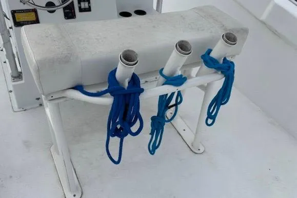 Slide: The Image of 1995 Cape Horn 21 boat rod holders with blue ropes on white deck. - 5