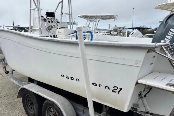 Slide: The Image of 1995 Cape Horn 21 boat on trailer, white hull, Yamaha engine visible. - 7