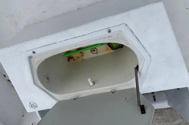 Slide: The Image of Open storage compartment on a 1995 Cape Horn 21 boat, showing interior details. - 8