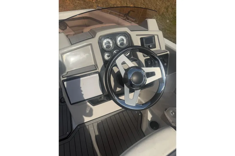 Slide: The Image of 2025 Starcraft SVX 211 OB boat dashboard with steering wheel and gauges. - 3
