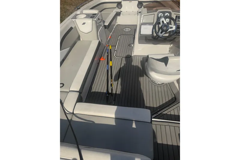 Slide: The Image of 2025 Starcraft SVX 211 OB boat interior with seating and steering console. - 4