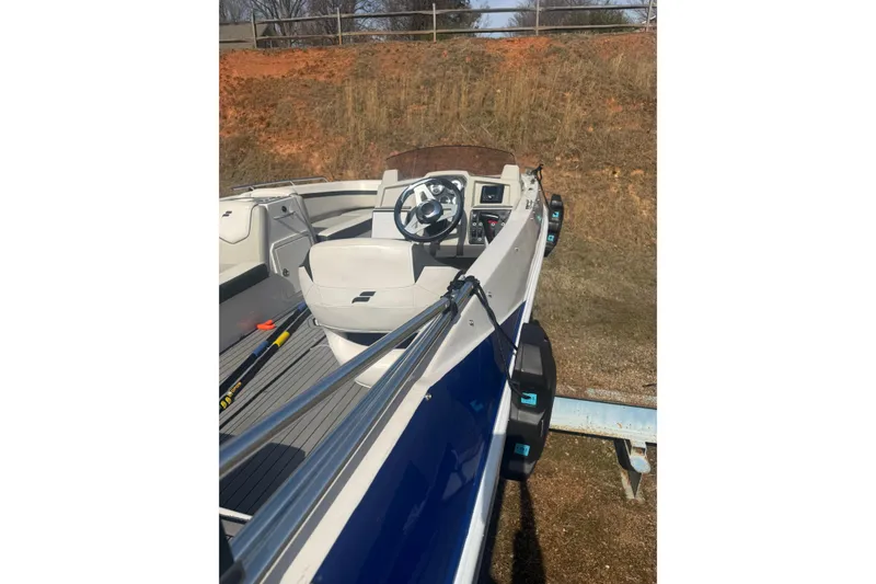 Slide: The Image of 2025 Starcraft SVX 211 OB boat interior with steering wheel and seating. - 7