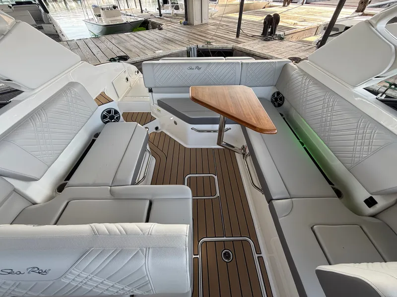 Slide: The Image of The image shows the cockpit of a Sea Ray SDX 250 with sleek seating and a wooden table. - 7