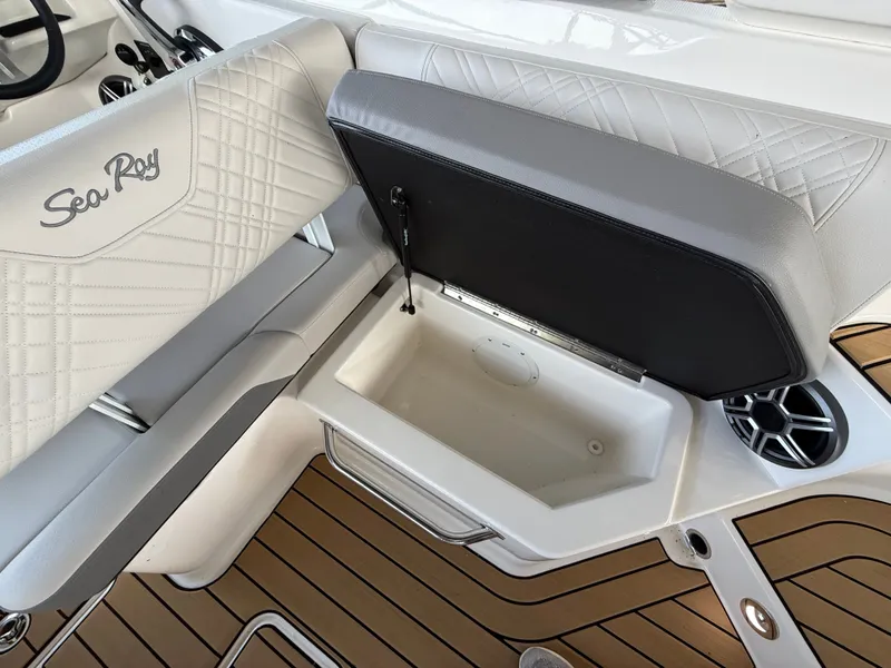 Slide: The Image of Interior of a Sea Ray SDX 250 with white upholstery and a built-in storage compartment. - 5