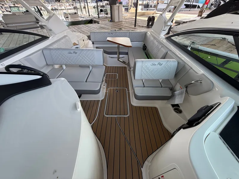 Slide: The Image of The image shows the cockpit of a Sea Ray SDX 250 boat with sleek white seating and a wooden table. - 13