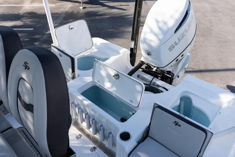 Slide: The Image of 2026 Sea Pro 230 Bay boat interior with Suzuki engine and storage compartments. - 12