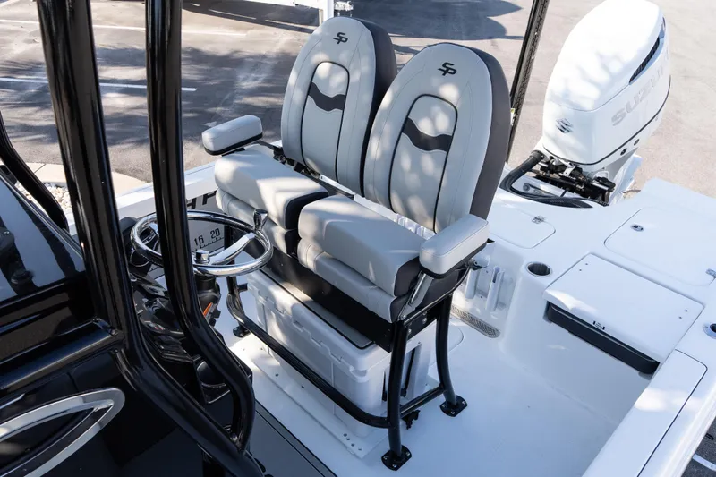 Slide: The Image of 2026 Sea Pro 230 Bay boat interior with dual seats and steering wheel. - 13