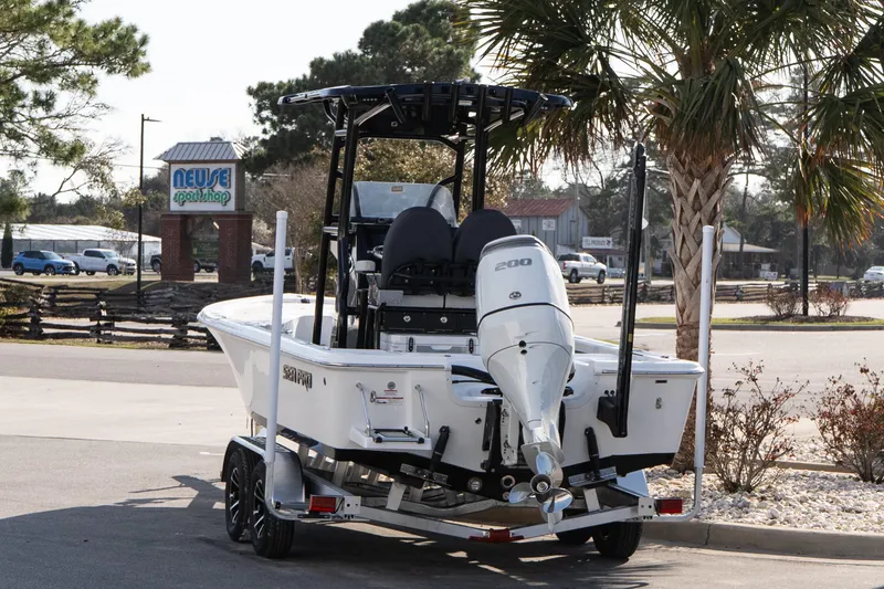 Slide: The Image of 2026 Sea Pro 230 Bay boat on trailer, parked near Neuse Sport Shop. - 4