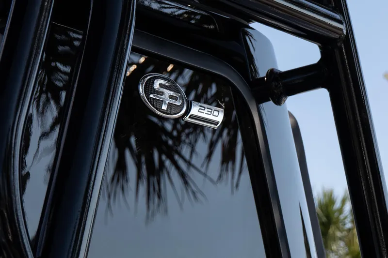 Slide: The Image of Close-up of 2026 Sea Pro 230 Bay boat emblem with palm tree reflection. - 7