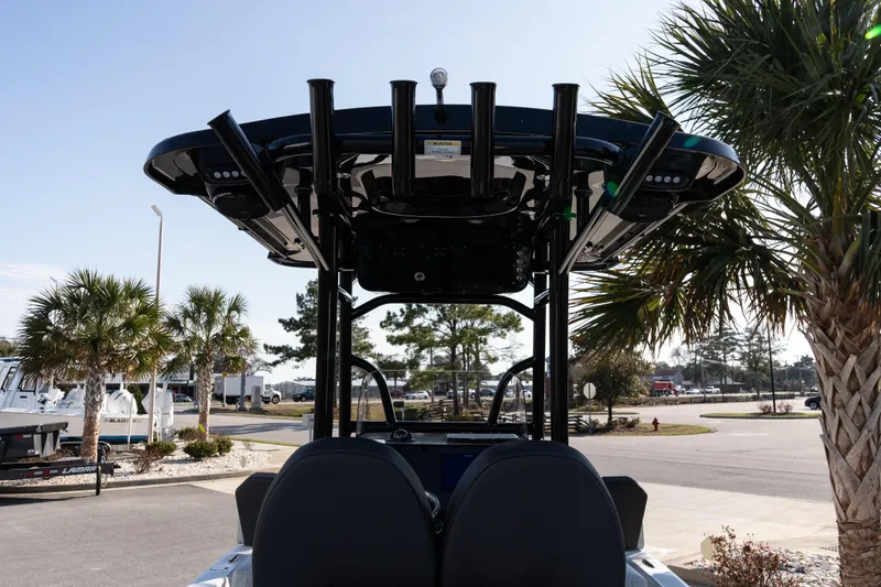 Slide: The Image of 2026 Sea Pro 230 Bay boat with T-top, parked near palm trees. - 8