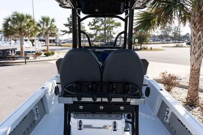Slide: The Image of 2026 Sea Pro 230 Bay boat interior with dual seats and palm trees in the background. - 9