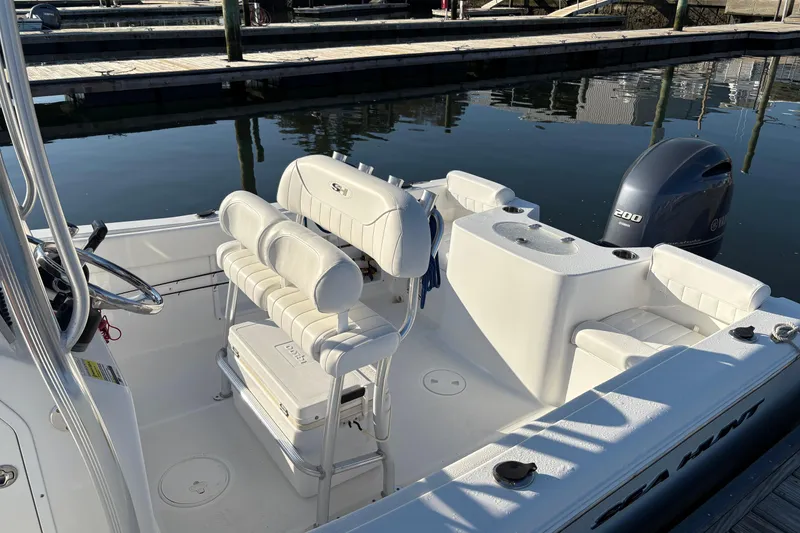 Slide: The Image of 2014 Sea Hunt Triton 225 boat interior with seating and Yamaha outboard motor. - 10
