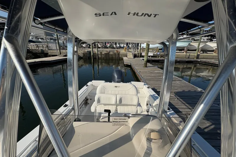 Slide: The Image of 2014 Sea Hunt Triton 225 boat docked at marina, featuring sleek design and comfortable seating. - 16