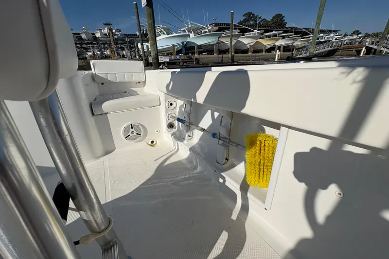 Slide: The Image of 2014 Sea Hunt Triton 225 boat interior with seating and cleaning equipment. - 20