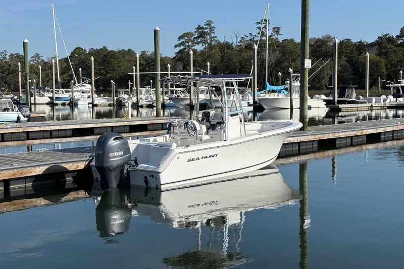 Slide: The Image of 2014 Sea Hunt Triton 225 boat docked in a marina with Yamaha engine. - 3