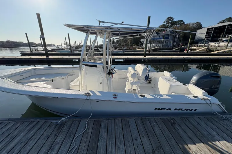 Slide: The Image of 2014 Sea Hunt Triton 225 boat docked at marina, featuring Yamaha outboard motor. - 5