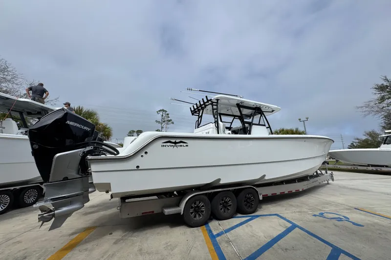 Slide: The Image of 2026 Invincible 36 Catamaran on trailer, featuring sleek design and powerful Mercury engines. - 11